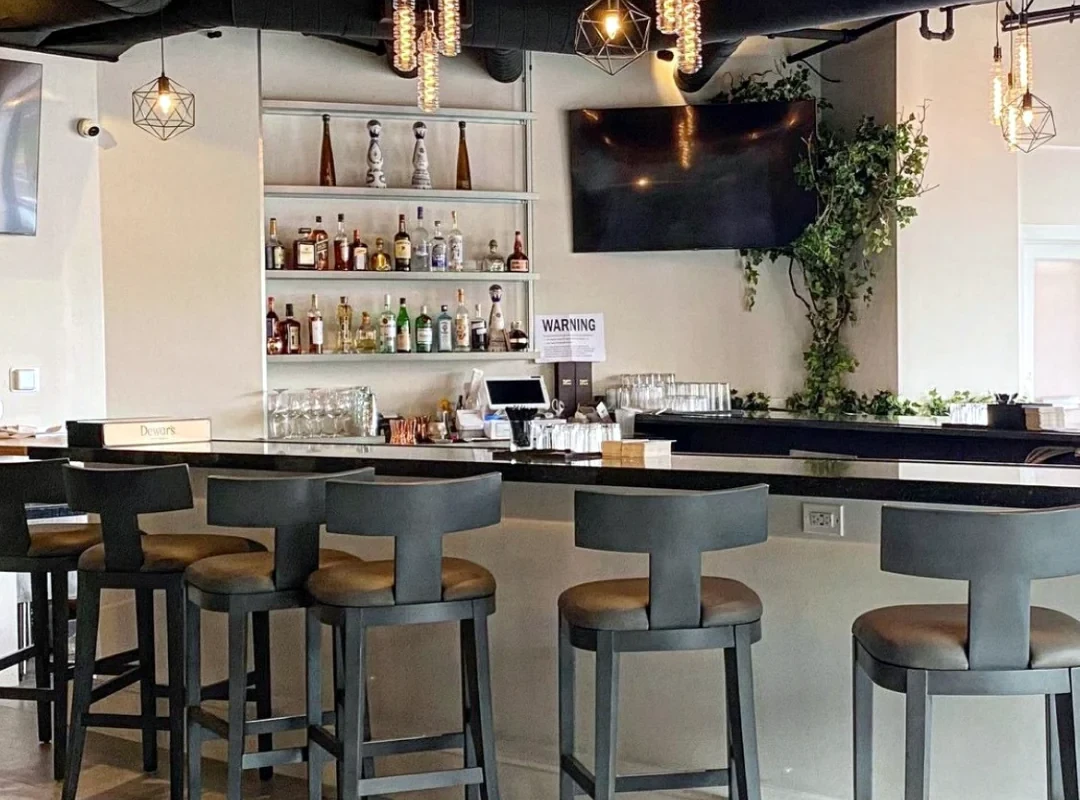 The Ivy Restaurant bar with pendant lighting, illuminated shelving and counter seatingREVIEW ONLY · New restaurant hub · Form does not submit
